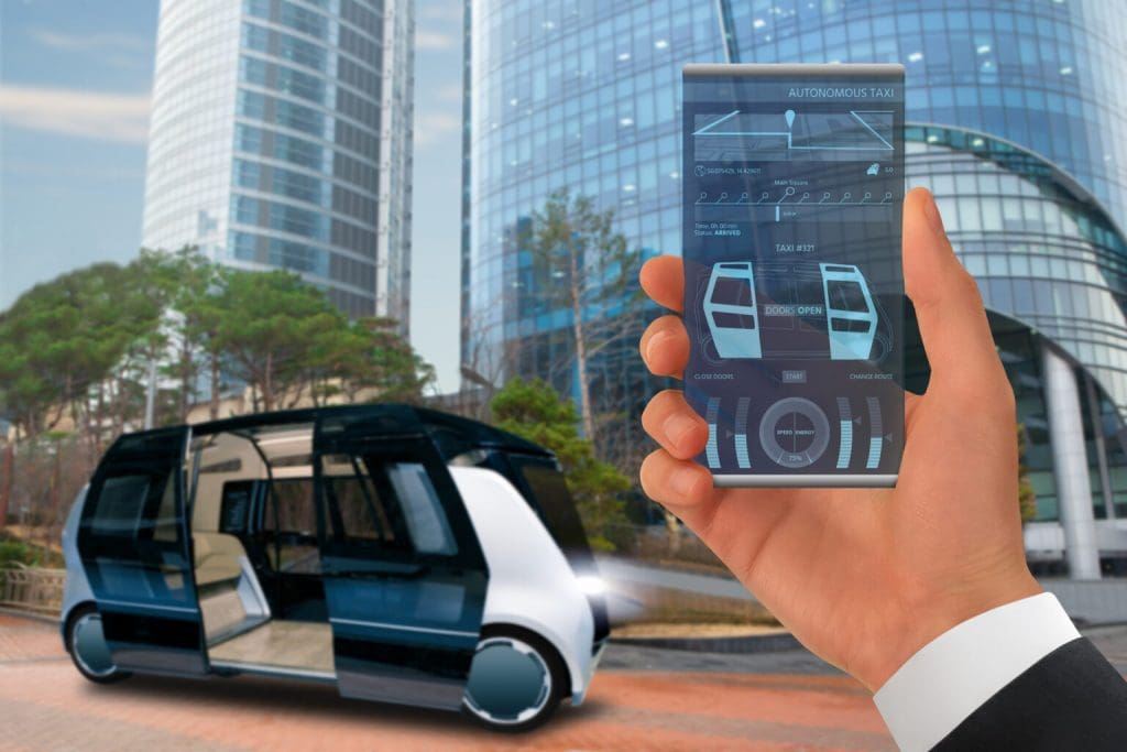 Person hailing an autonoumous taxi with a smartphone 1536x1024 1