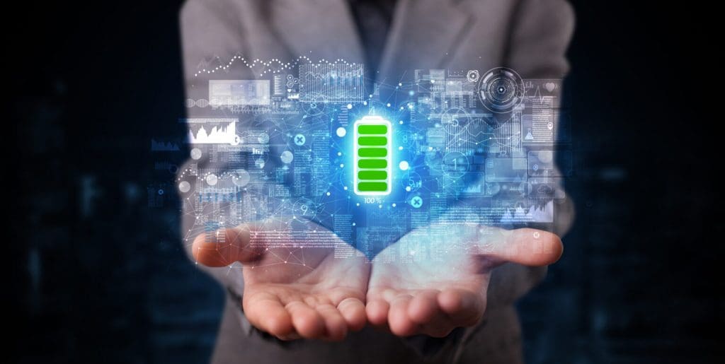 Person holding a fully charged battery with blue technology wireframe 1536x773 1