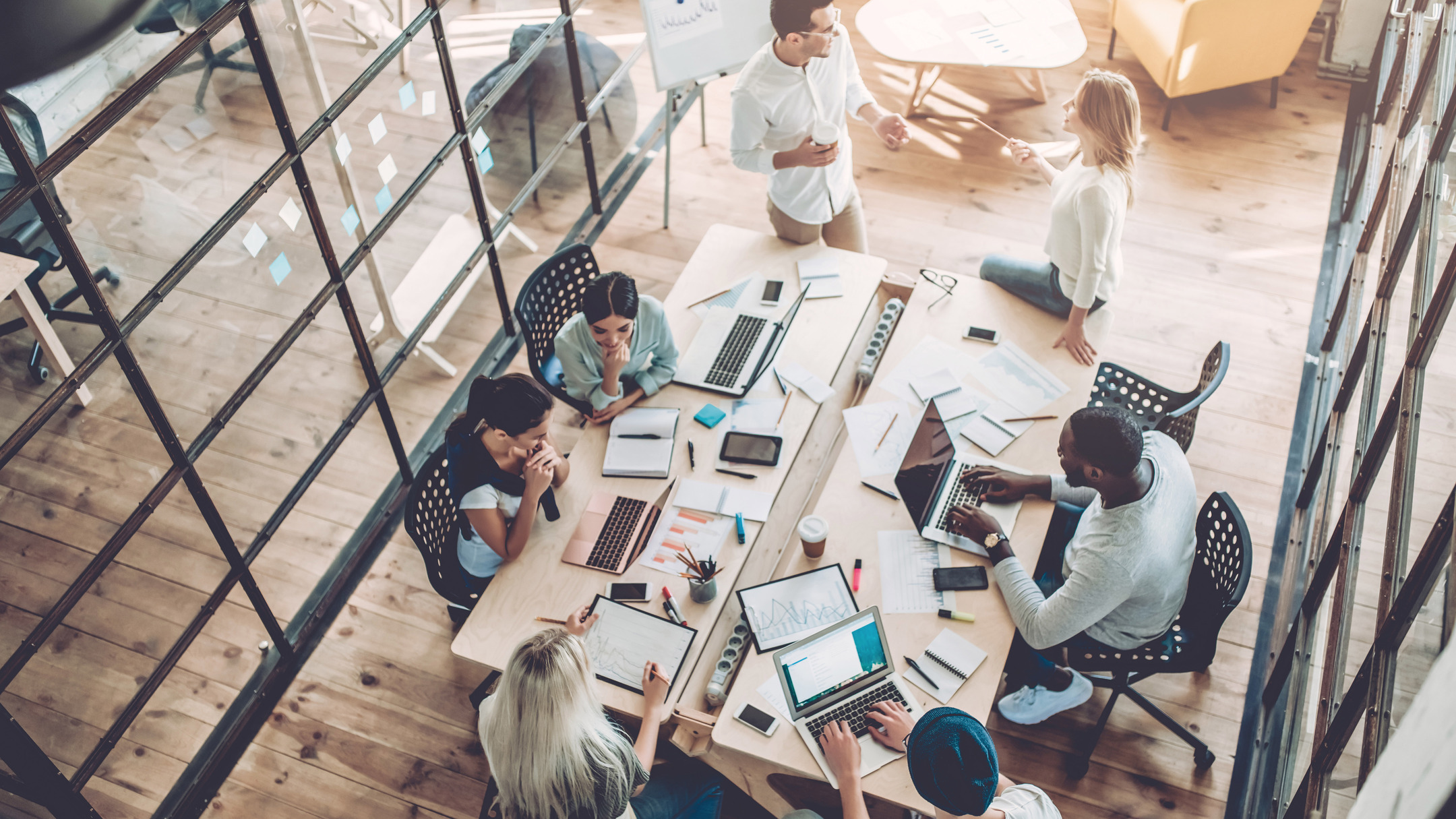 NX CAD packages for small and medium businesses (SMB) - NX Design 2 Group of young business people are working together with laptop, tablet, smart phone, notebook.